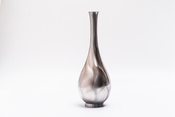 Isolated silver, reflective chrome, tall vase on a white studio background