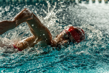 Swimmer at the pool swimming freestyle