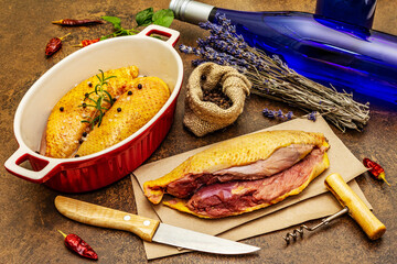 Preparation raw duck breasts with sea salt, fresh rosemary, dry lavender and chili