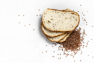 Flax seeds in a sack, sliced bread. Space for text, top view, flat lay.