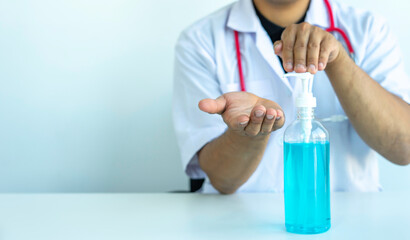 Fototapeta premium The doctor is pressing alcohol gel to clean hands to stop transmission before and after touching the patient, alcohol gel cleansing concept. And stopping the transmission of infection