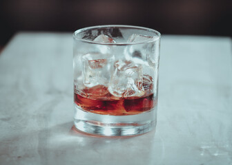 A glass of rum on the rocks.