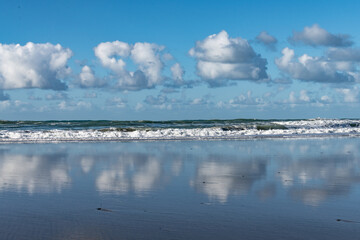 sky, clouds and wet sand at the coast