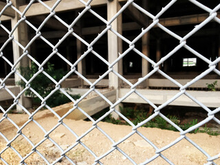 Fototapeta premium Wire stainless steel grey color, chain link fence, seamless texture metal wire protective fence.