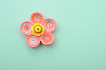 Quilling of paper flower on green background