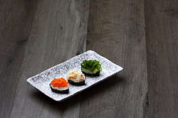 Sushi Set sashimi and sushi rolls served on wood background