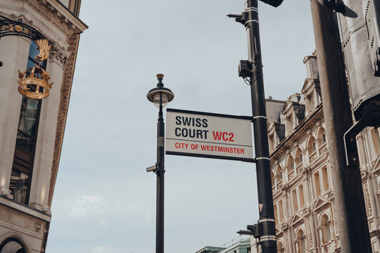 London, UK - June 13, 2020: Street Name Sign On Swiss Court In Soho, An Area Of London Famous For Its Shops, And Restaurants, On A Sunny Summer Day.