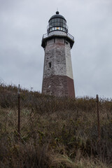 The historic Montauk Point Lighthouse under renovation construction. The original bricks are exposed under the old paint.Located in Montauk Point State Park, New York