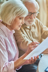 Elderly husband and wife discussing budget planning