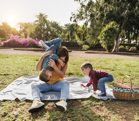 Mother and twin sons have playful time in nature park with pic nic - Mother and children love