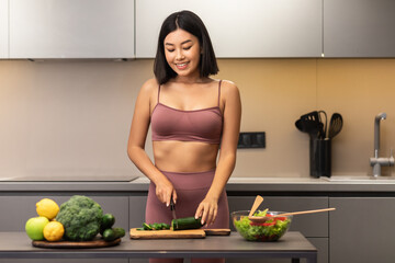 Obraz na płótnie Canvas Skinny Asian Woman Cooking Preparing Healthy Dinner Standing In Kitchen