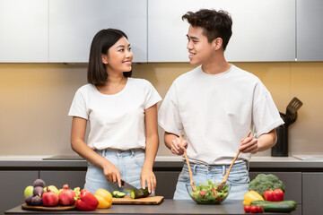 Asian Family Couple Cooking Together In Modern Kitchen Preparing Dinner