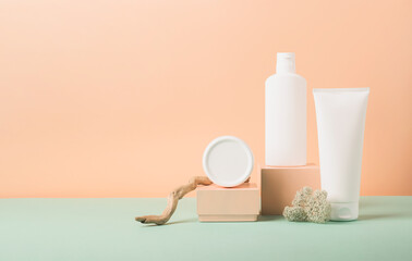 Cosmetic vials tube bottles white on modern abstract podium on pastel background