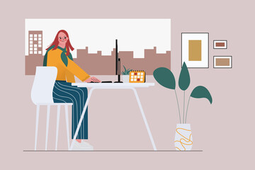 Young woman working with a laptop at the window in the room.