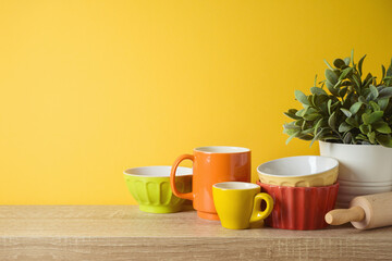 Kitchen utensils and dishware on wooden shelf. Autumn kitchen interior background