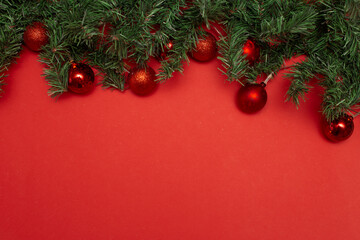 Christmas fir branches and balls red background