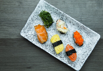 Sushi Set sashimi and sushi rolls served on wood background
