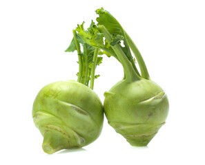 Fresh kohlrabi with green leaves on isolated white