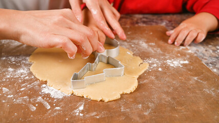 Mom and child make a mold for New Year's cookies