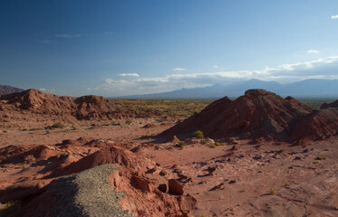 Desert landscape. Beautiful view of the red sand, sandstone, canyon, valley and mountains at sunset.