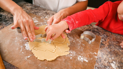 Mom and child make a mold for New Year's cookies