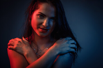 Portrait of a young woman in the Studio in colored red and blue light