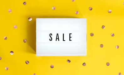 Lightbox with a sign sale starts on yellow festive background. Concept sale, black friday, cyber...