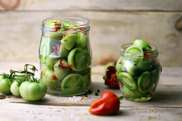 Green tomatoes are pickled in jars. Fermentation of tomatoes. Probiotics.