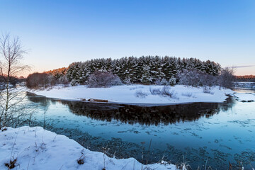 Panorama with winter forest and river. Sunrise, sunset in beautiful snowy forest.