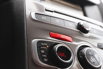 Emergency warning button on the instrument panel in the car.