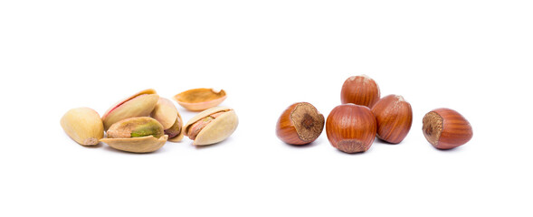 Pile of roasted pistachios and hazelnuts isolated on white background
