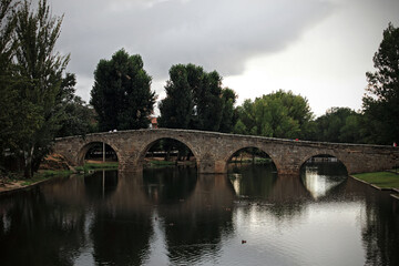 Fototapeta premium Old bridge over river in Spain, Europe