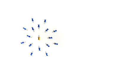 Yellow push pin in the center of the blue push pins with their spike facing yellow. The concept of aggression and attack