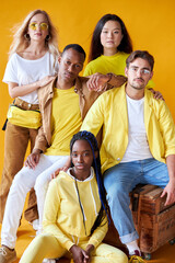 group of multiethnic friends, people of different cultures isolated on yellow background, good-looking men and women in stylish wear posing, students in one country