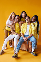 Obraz premium studio shoot of encouraged models of diverse races isolated on yellow background, beautiful guys and ladies happy to be in one group, team, country, friendship concept
