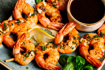 Delicious roasted shrimps on plate with lemon