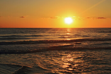 Fototapeta na wymiar Yellow and red sunrise on the beach, sea landscape