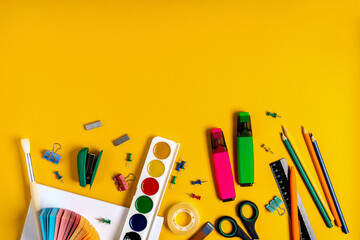 School supplies for studying and drawing on a yellow background. The concept of school and preschool