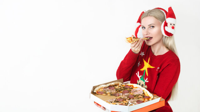 Christmas pizza and fastfood delivery. Blonde girl in santa hat with pizza box in hands isolated on white background. Copyspace. Billboard