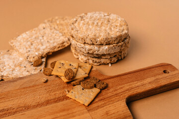 Various types of healthy whole grain crispbreads and cookies on a brown cozy background on a wooden Board.