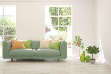 Fototapeta premium White living room with sofa and summer landscape in window. Scandinavian interior design. 3D illustration