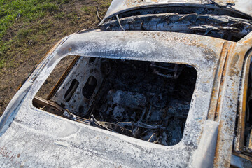 Burned down car, abstract background, selective focus. The situation of protests in the world.