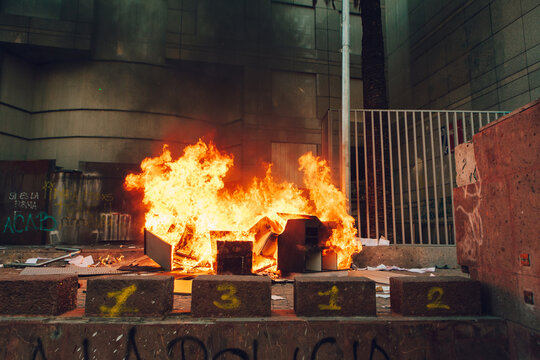 People loot and burn a office building during a protest in Chile