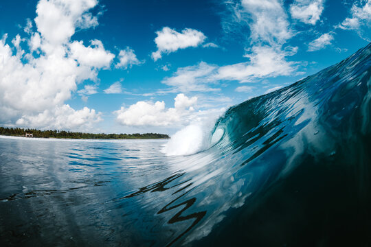 Powerful blue breaking ocean waves with white foam