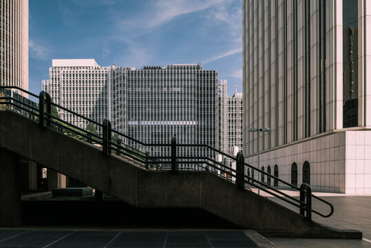 Stone staircase in city on background of tall contemporary skyscrapers on sunny day