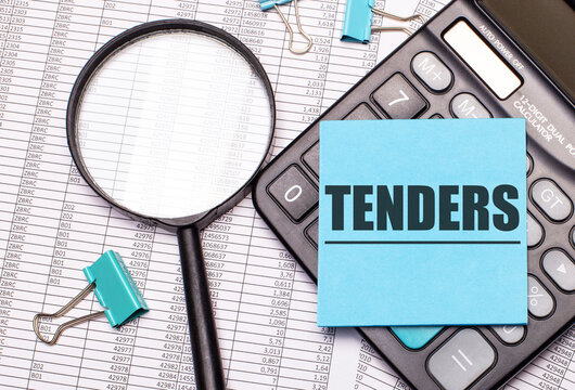 On the table are reports, a magnifying glass, a calculator, and a blue note sticker with the word TENDERS. Business concept