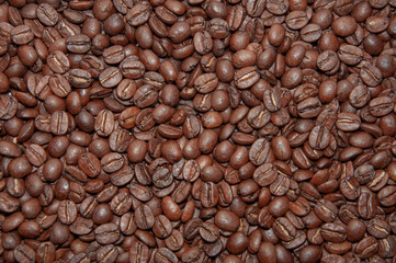 Dark roast coffee beans background, top view