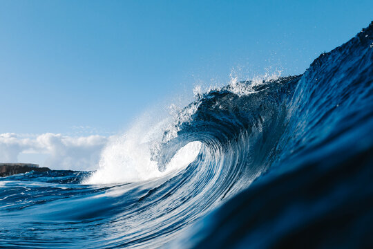 Powerful blue breaking ocean waves with white foam