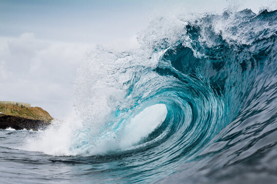 Powerful turquoise breaking ocean waves with white foam