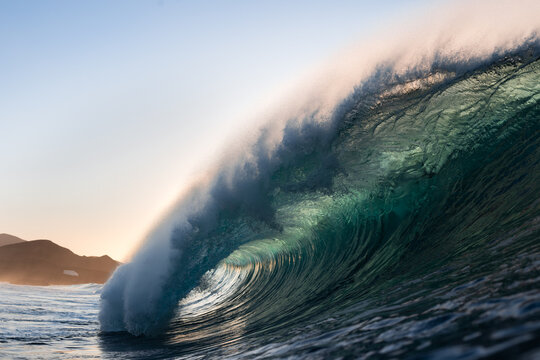 Powerful turquoise breaking ocean waves with white foam